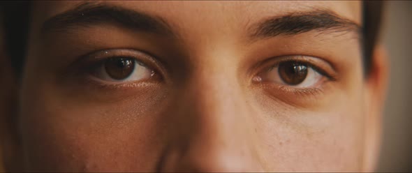 Closeup of a young man eyes staring at the camera