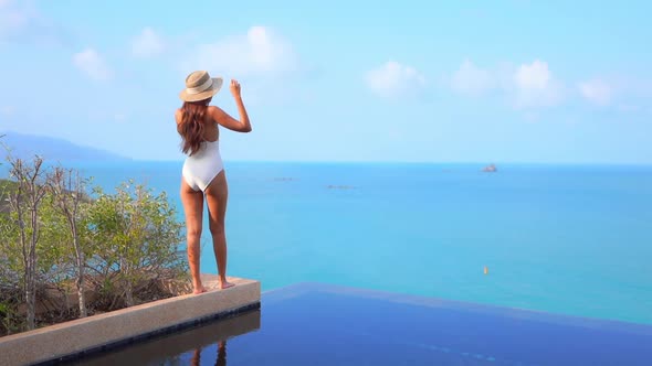 Young asian woman enjoy around outdoor swimming pool for leisure