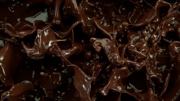 Super Slow Motion Shot of Splashing Melted Chocolate Background at 1000 Fps alt
