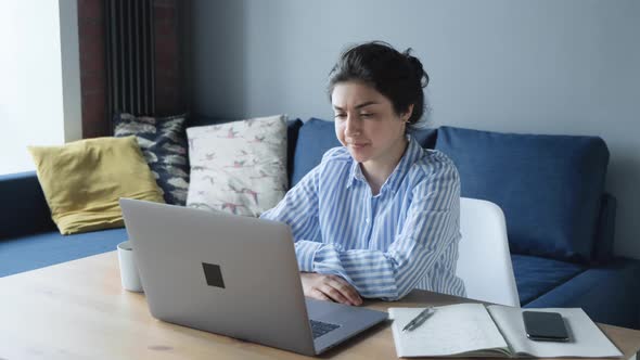 A Serious Young Indian Woman Is Upset And Worried About Working On A Computer 