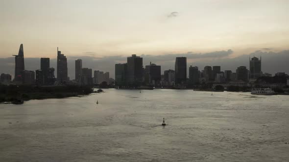 Saigon River day to night time lapse with Ho Chi Minh City Skyline at golden hour. Featured are rive