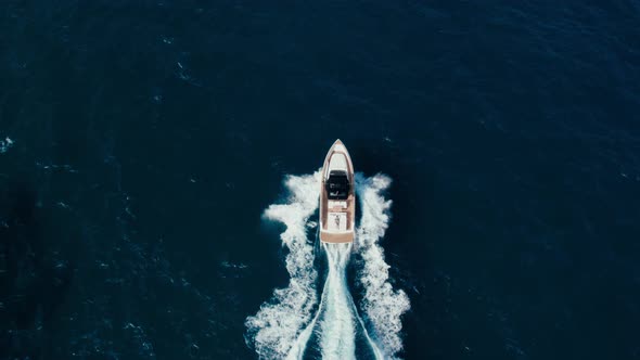 Drone Shot of Motorboat in Open Blue Water on Wave