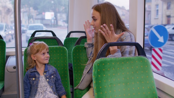 Stressed Annoyed Mother Nagging Shouting at Rebellious Kid Girl Child in Public Bus Transport