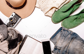 , jeans, phone, notebook, shoes lie on the white background