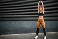 Portrait of fit and sporty sexy woman doing stretching in city urban landscape - PhotoDune Item for Sale