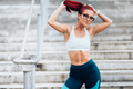 Portrait of  sexy fit woman wearing sportswear and showing abs during workout - PhotoDune Item for Sale