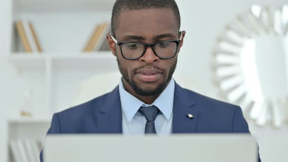 Portrait of Professional African Businessman Working on Laptop 