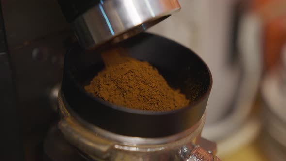 Professional Barista Worker Man Using Grinder Machine To Grind Fresh Coffee Beans for Make Hot