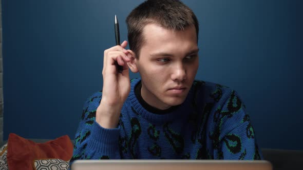 Thoughtful Serious Young Caucasian Man Student Writer Sits Home Office Desk Laptop Thinking