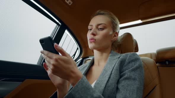 Portrait Woman Sitting with Phone Backseat. Female Using Smartphone at Car