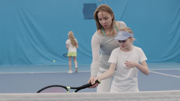 Little Girl On Tennis Training With Coach