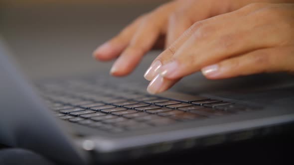 Hands typing on laptop computer. Freelancer woman doing distant work on notebook