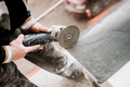 Construction site details - industrial tool, worker with angle grinder cutting marble stone - PhotoDune Item for Sale