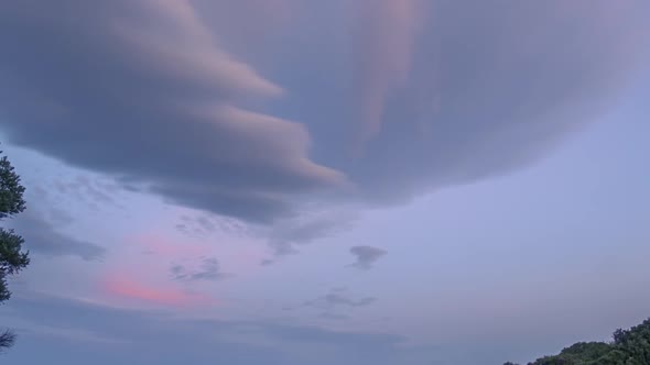 Sunset Clouds Over a Small Rocky Beach