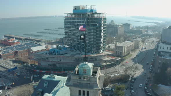 Aerial Drone Shot Orbiting an American Flag atop an old Staten Island Building