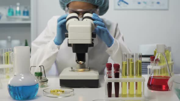 Female Lab Assistant Doing Biochemical Research, Experimental Medicine