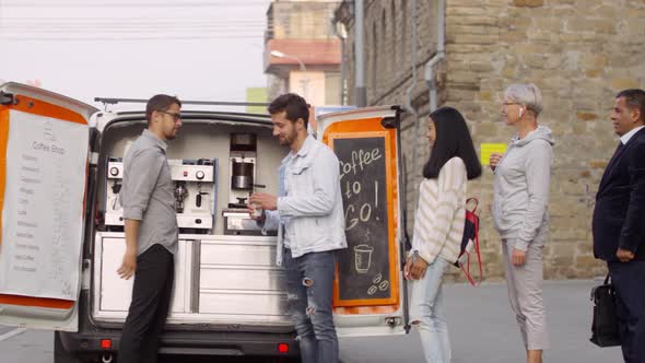 Diverse Customers Queuing to Mobile Coffee Van in Street