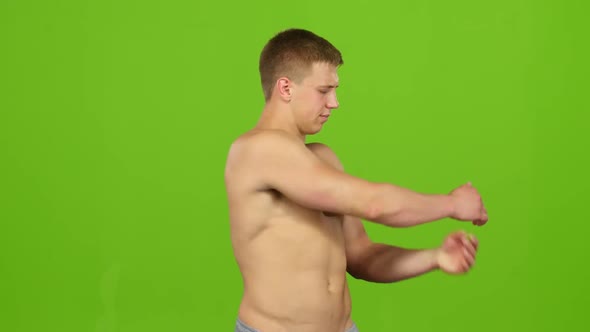 Athlete Warms Up Muscles Before Training on Green Screen. Closeup