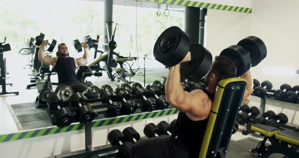 Young Strong Man Performing Incline Dumbbell Press, Gym Workout,intense Exercise, Weight Lifting