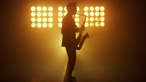 Silhouette Jazz Musician Playing Saxophone in Spotlights