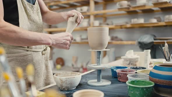 Unrecognizable Artist Preparing Raw Clay for Molding Watering It at Studio Workplace Tracking Shot