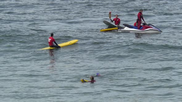 A group of lifeguards and their paddleboards.