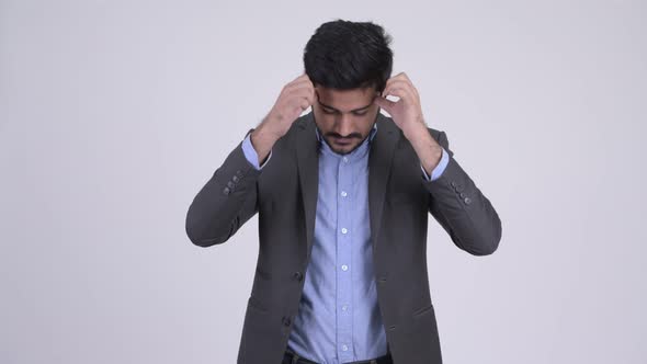 Young Stressed Bearded Indian Businessman Having Headache