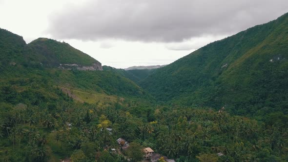 Beautiful aerial flying through a valley covered by forest in central Cebu near Osmena Peak in the P