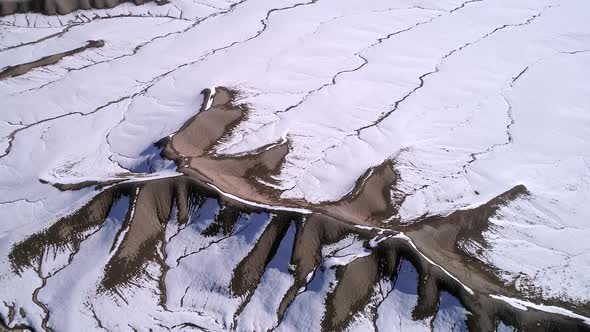 Aerial view flying over Utah desert terrain in winter landscape