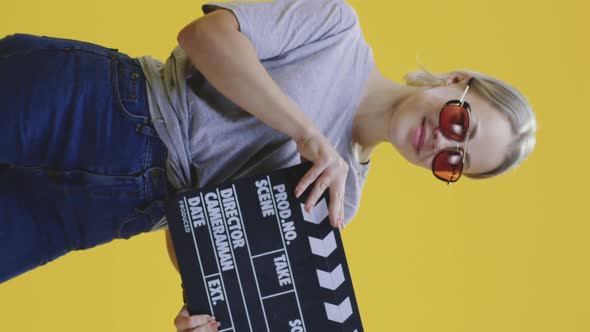 Cheerful Woman Clapping Clapperboard