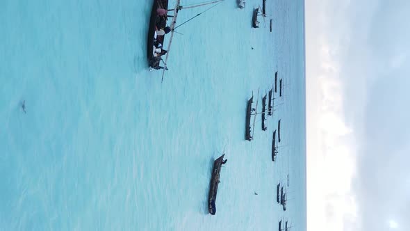 Vertical Video Boats in the Ocean Near the Coast of Zanzibar Tanzania Aerial View