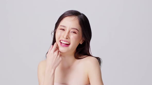 Beautiful Asian young woman touching chin smile with clean and fresh skin Happiness