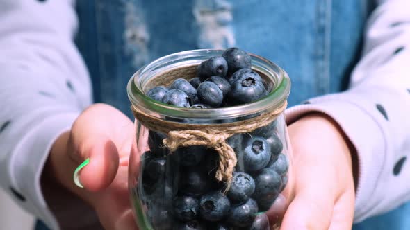 Woman Holding Bowl with Fresh Blueberries