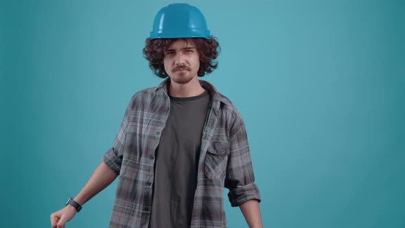 The Charismatic Young Man with the Engineer's Helmet Looks Suspiciously at the Soup That Points to