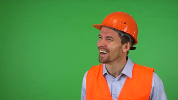 A Young Handsome Construction Worker Celebrates - Green Screen Studio