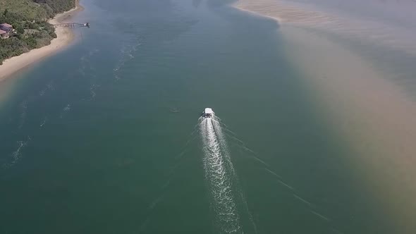 Tour boat keeps to deep channel in Knysna Lagoon, rotating aerial