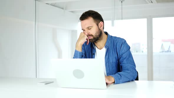 Tired Sleeping Man on Desk in Office