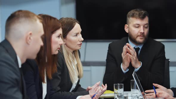 Business People Nodding with Agreement at Meeting