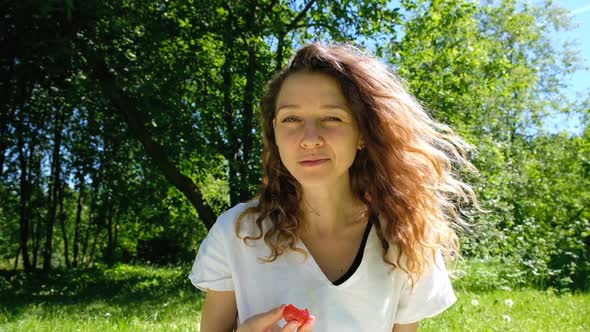 European Girl Eating Strawberries in Nature Slow Motion
