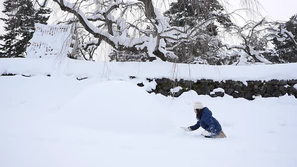 Cute Asian Girl Playing On Snow In The Park Together