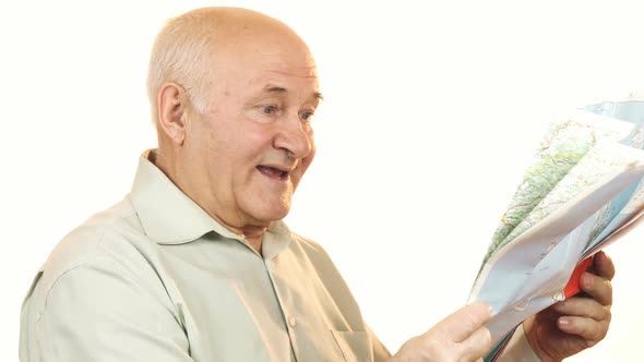 Happy Senior Man Using a Map Smiling Joyfully