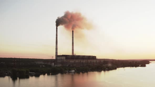 Aerial view of high smoke stack with smoke emission