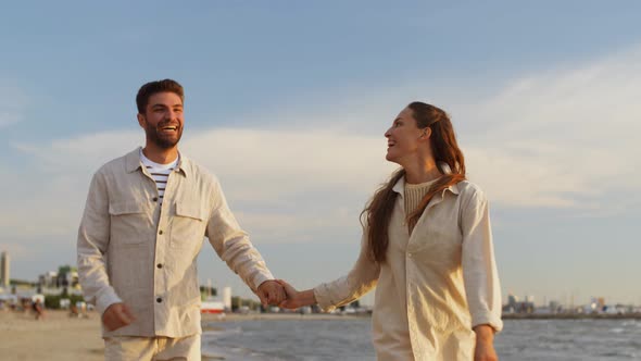 Happy Couple Running Along Summer Beach