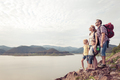 Happy family standing near the lake at the day time. - PhotoDune Item for Sale