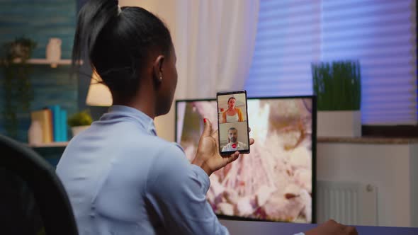 Black Young Lady Discussing on Webcam with Family Using Smartphone