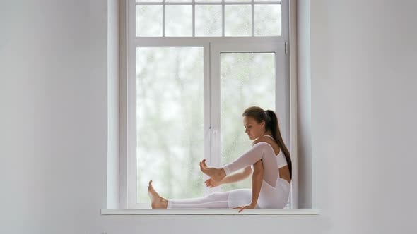 Sporty Young Woman Doing Yoga Practice at Home