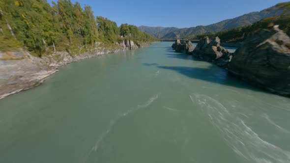 Extreme Aerial Panorama View Woman Raising Hands Freedom on Cliff Stone Structure River Scenery