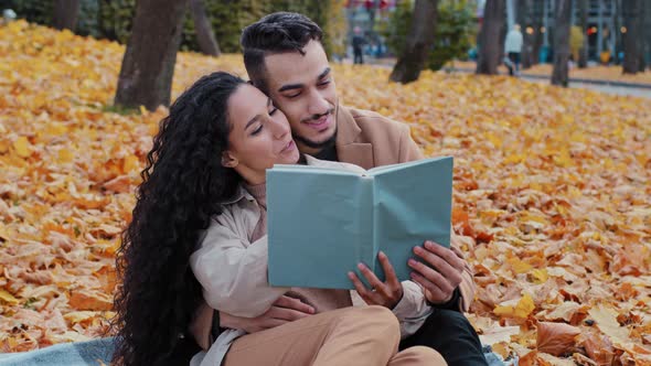 Young People Communicate Sitting in Yellow Leaves Outdoors Romantic Date in Autumn Park Beautiful