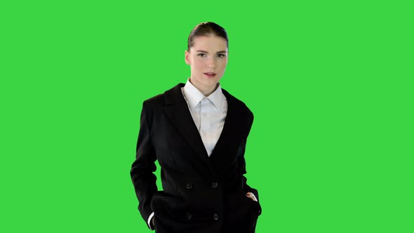 Young Woman in Office Suit Walking in Fashionable Style on a Green Screen Chroma Key