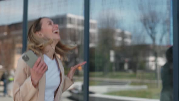 Woman Celebrating Record Sales Near Business Office